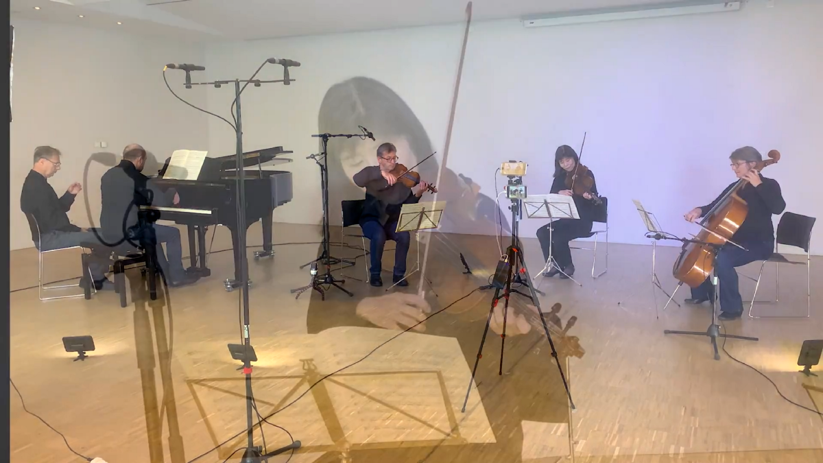 A piano quartet in an unusual setup, all in a semicircle including the piano, which is usually behind